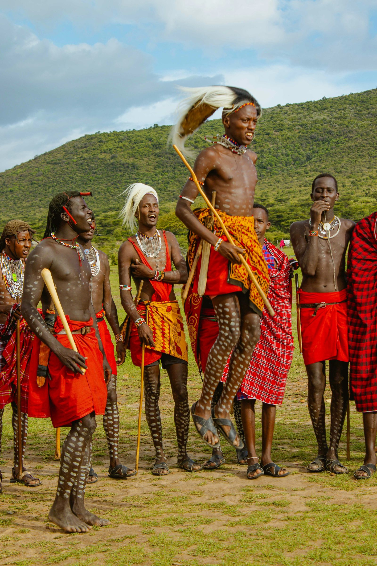 Maasai people in traditional red clothing standing outdoors