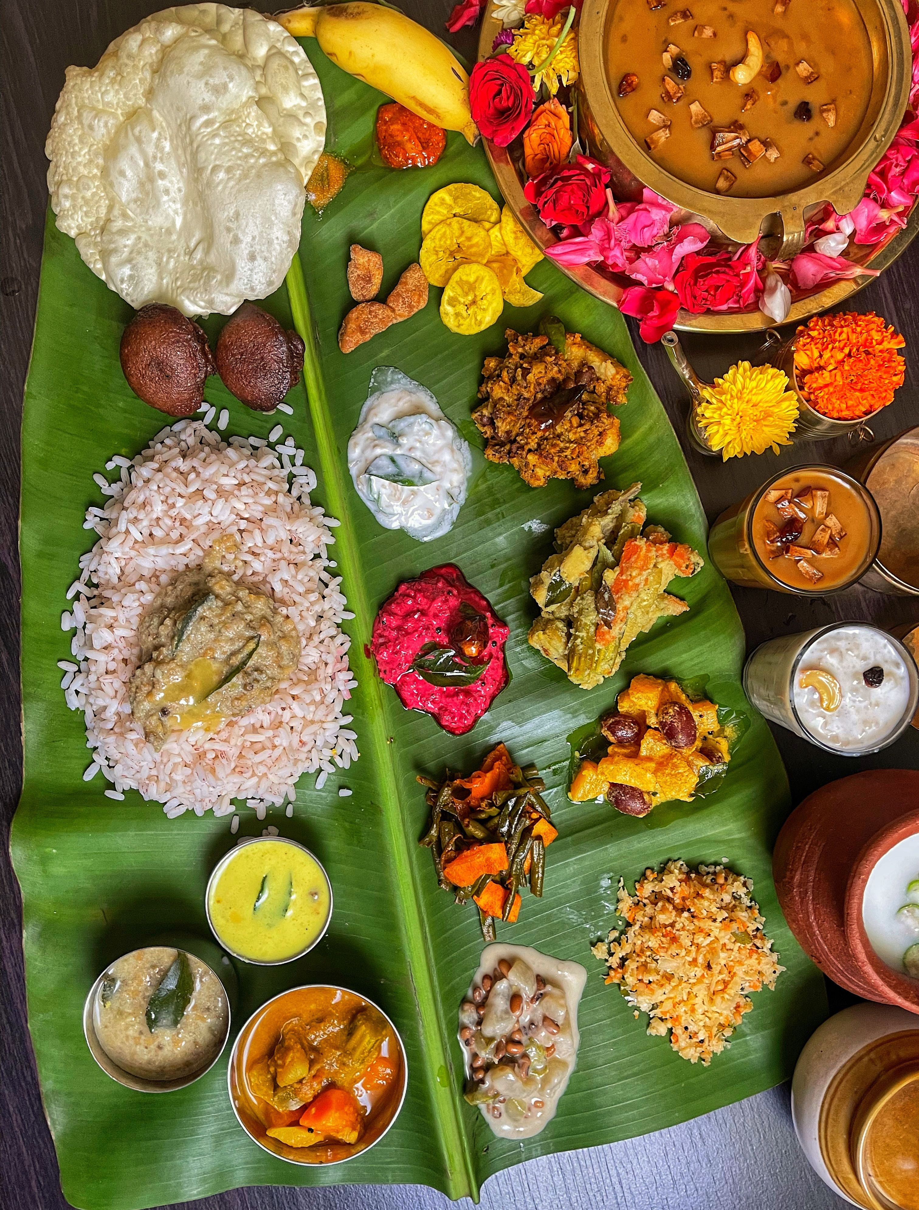 A Kerala sadya spread of rice and assorted dishes served on a banana leaf.