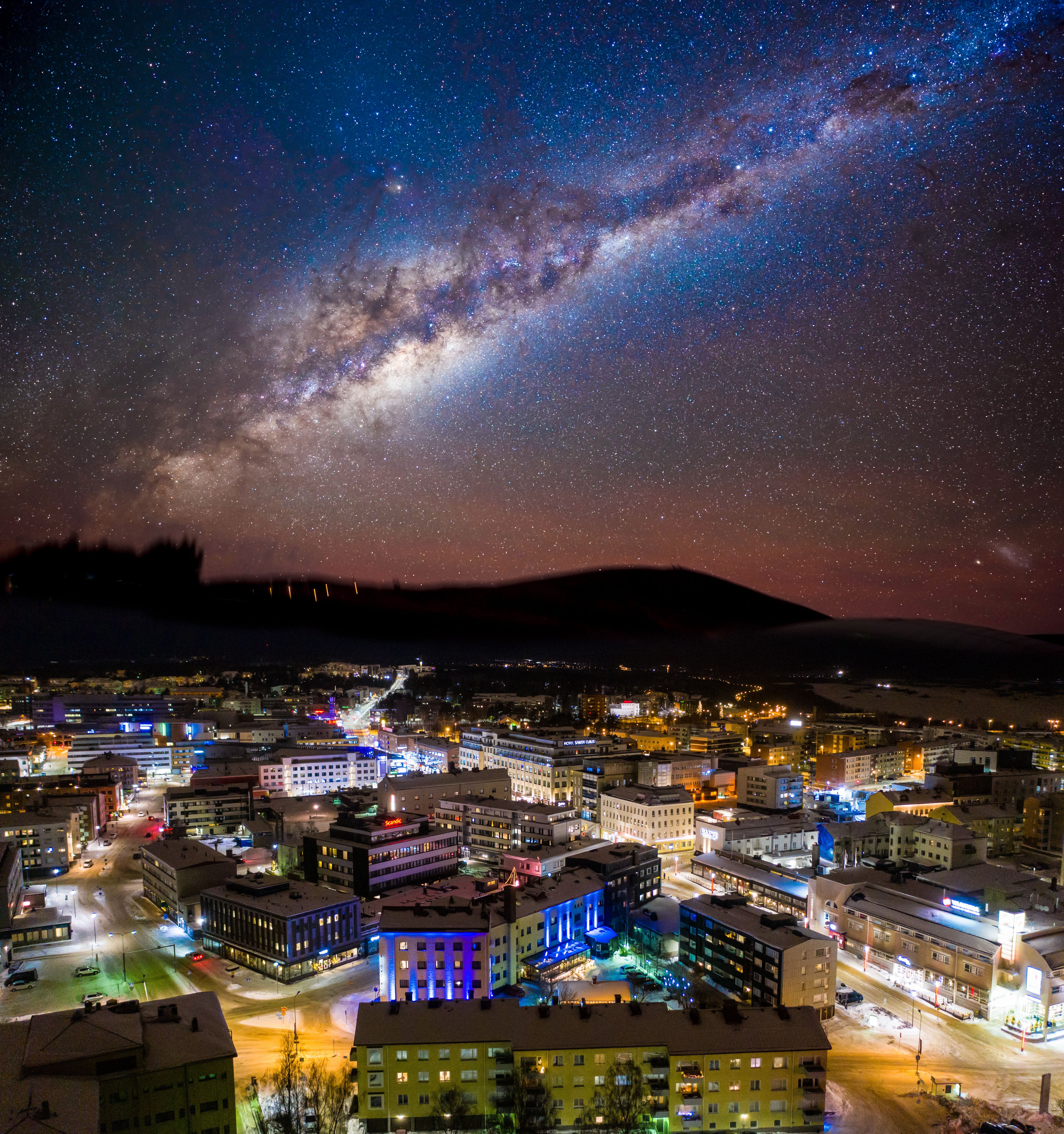 Rovaniemi city lights beneath a star-filled Arctic sky