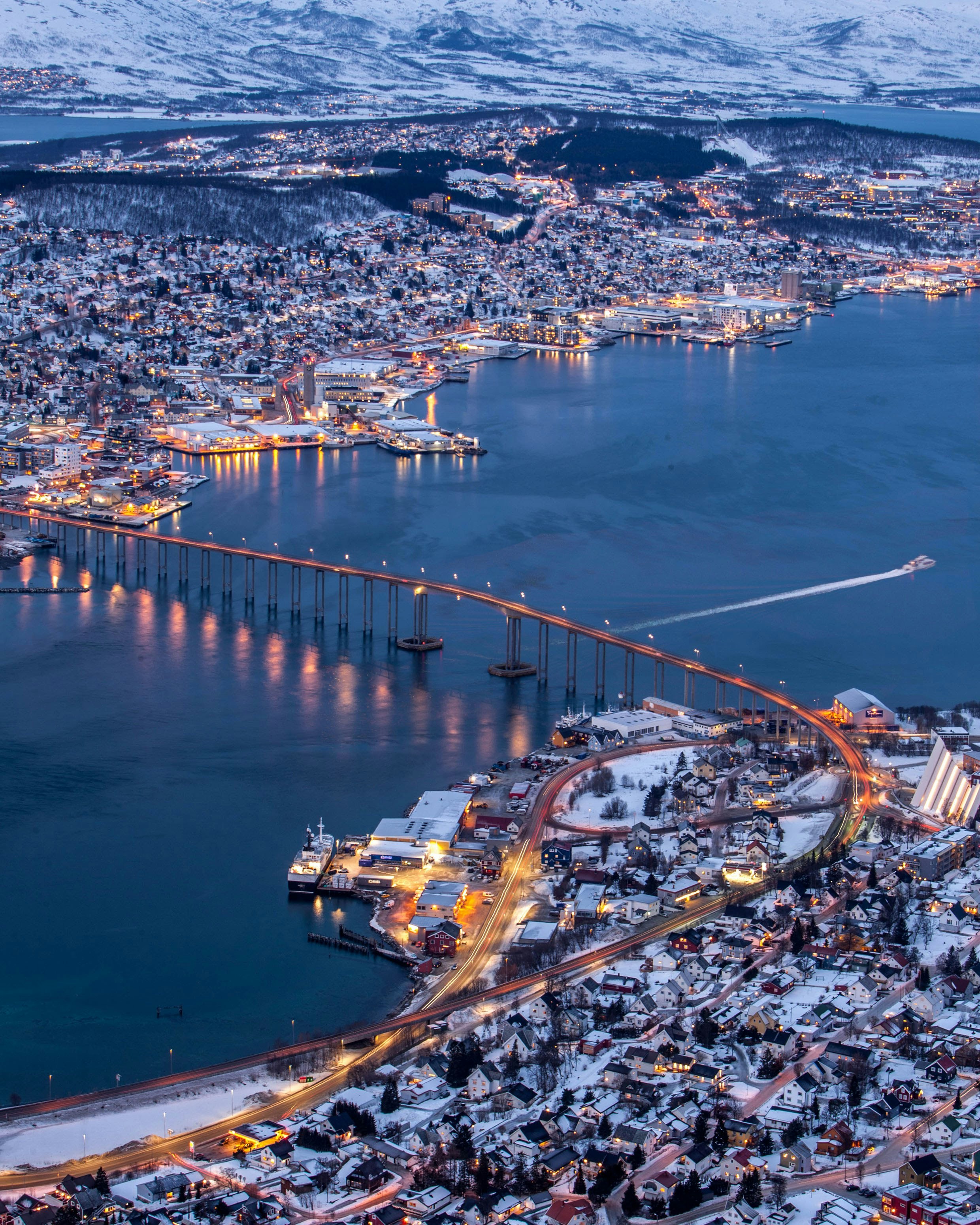 Aerial view of Tromsø’s waterfront and bridges at twilight