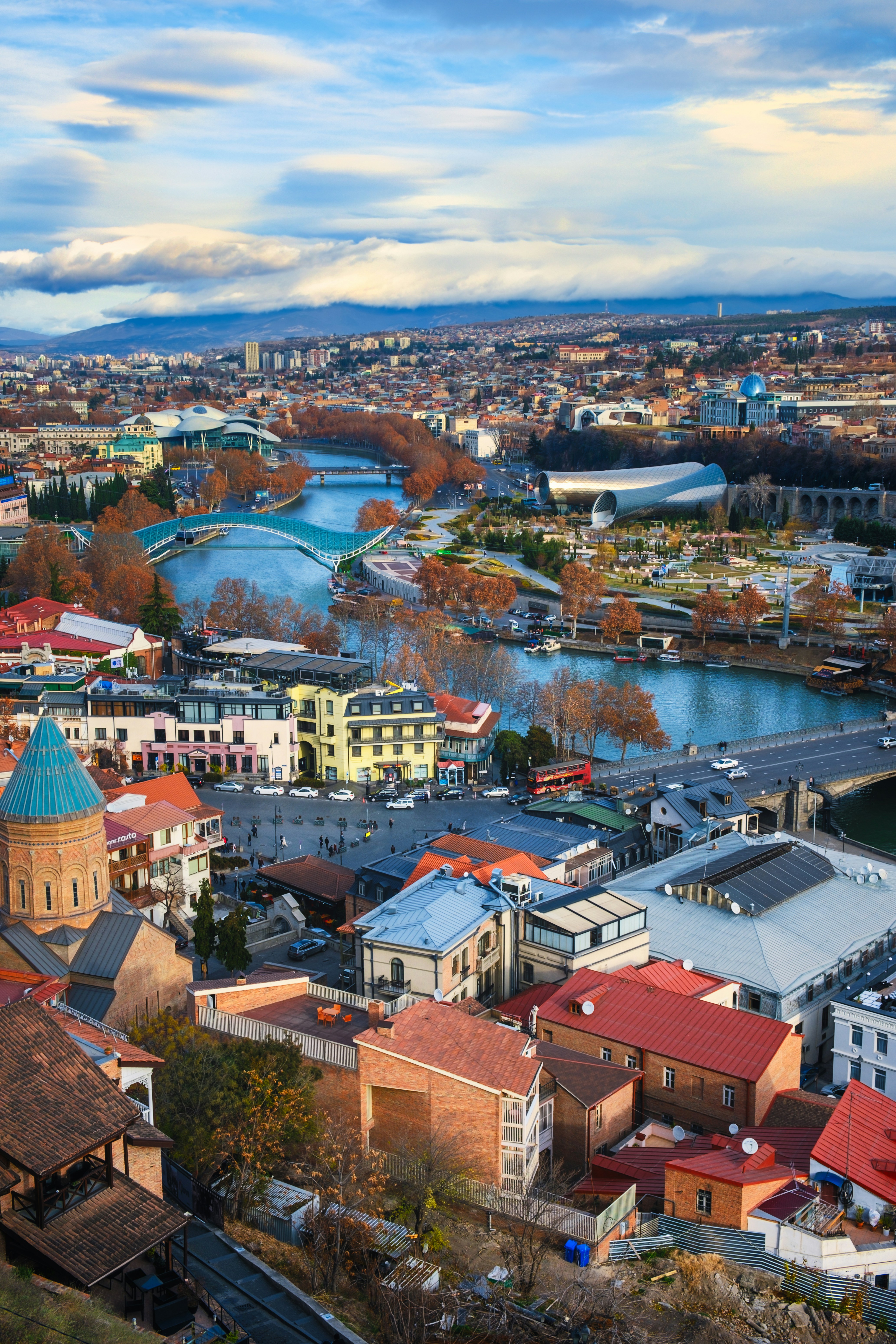 Aerial view of Tbilisi’s riverfront, bridges and hillside buildings