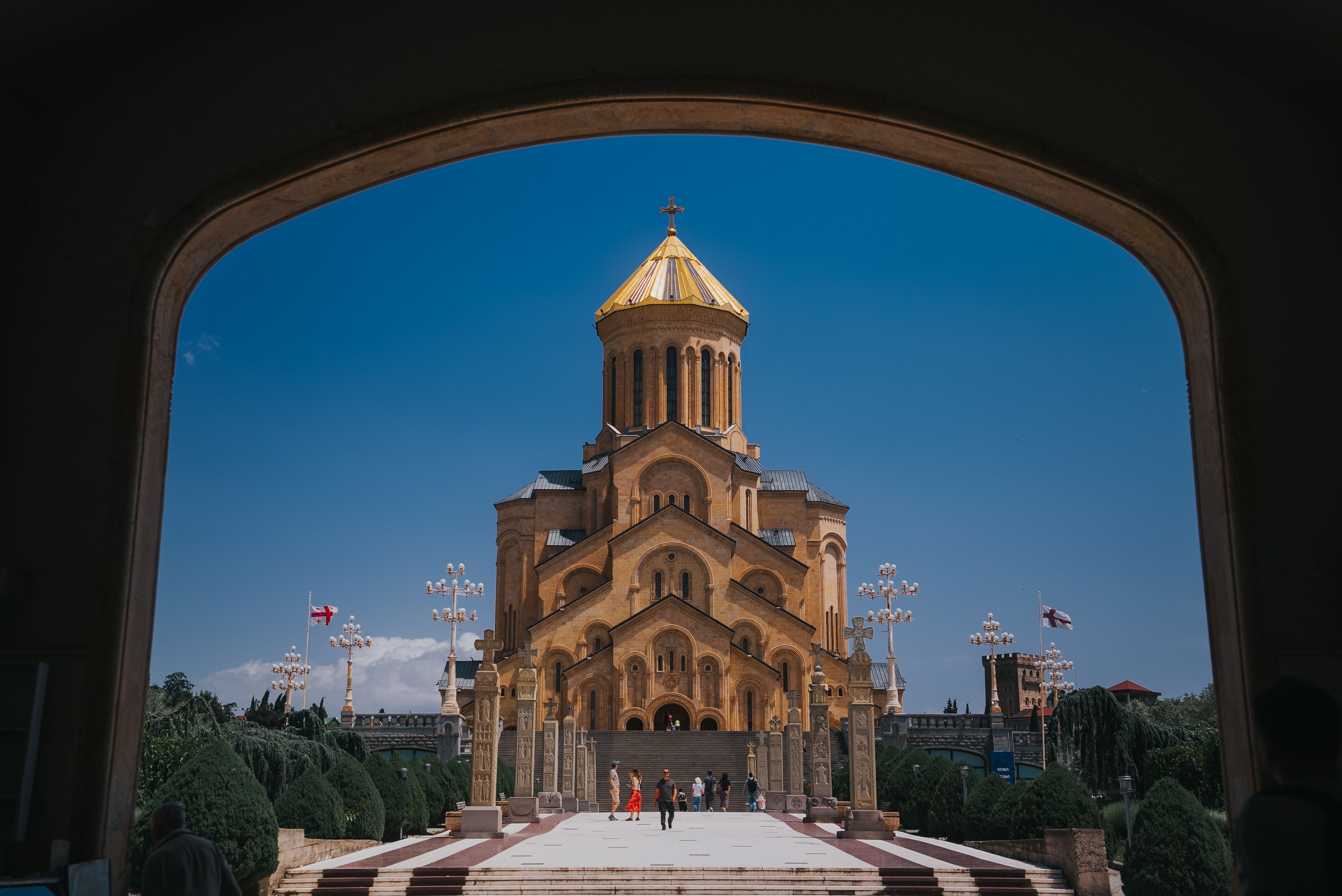Holy Trinity Cathedral in Tbilisi framed by an arched stone opening