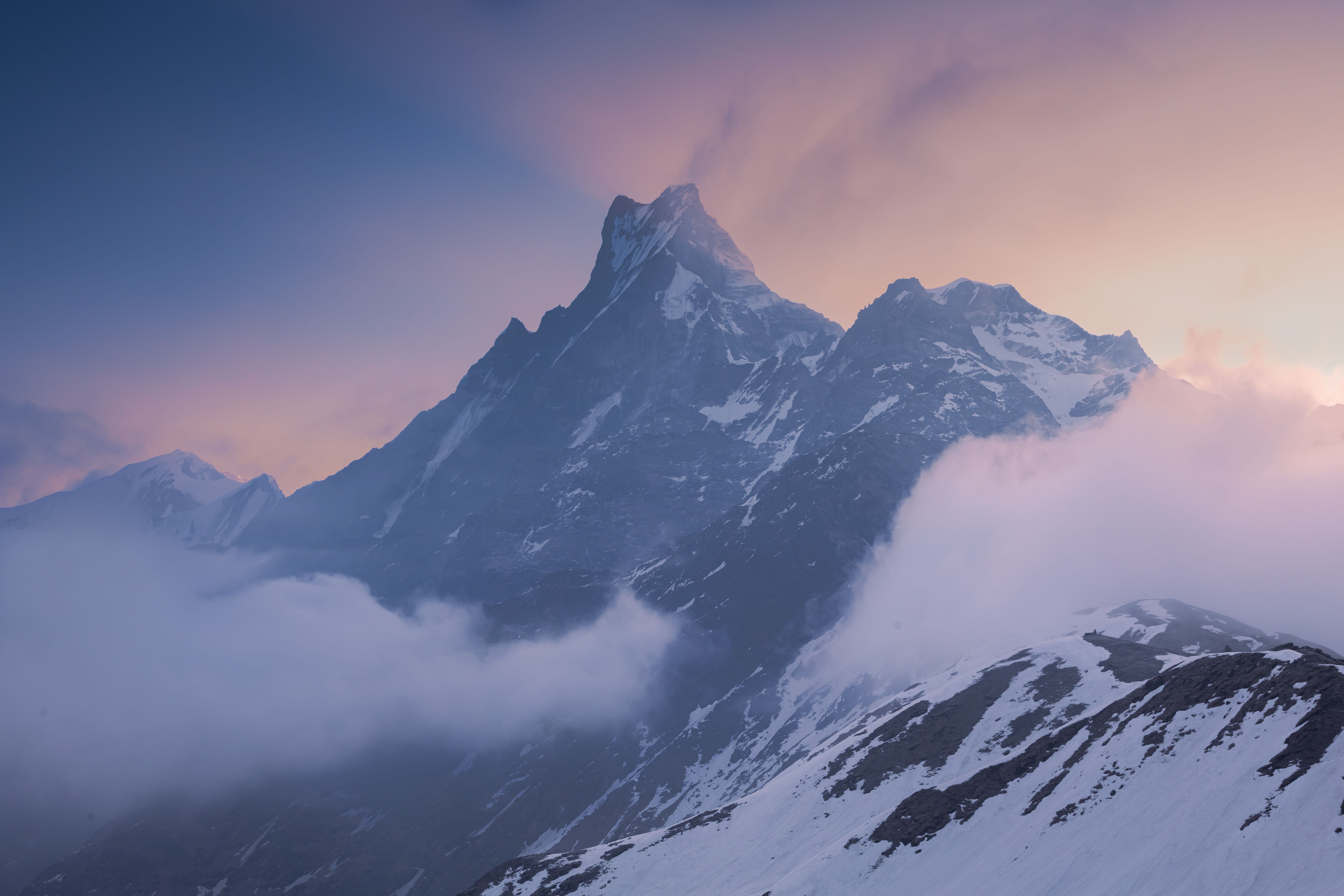 Snow-covered Himalayan peaks emerging through clouds above Pokhara