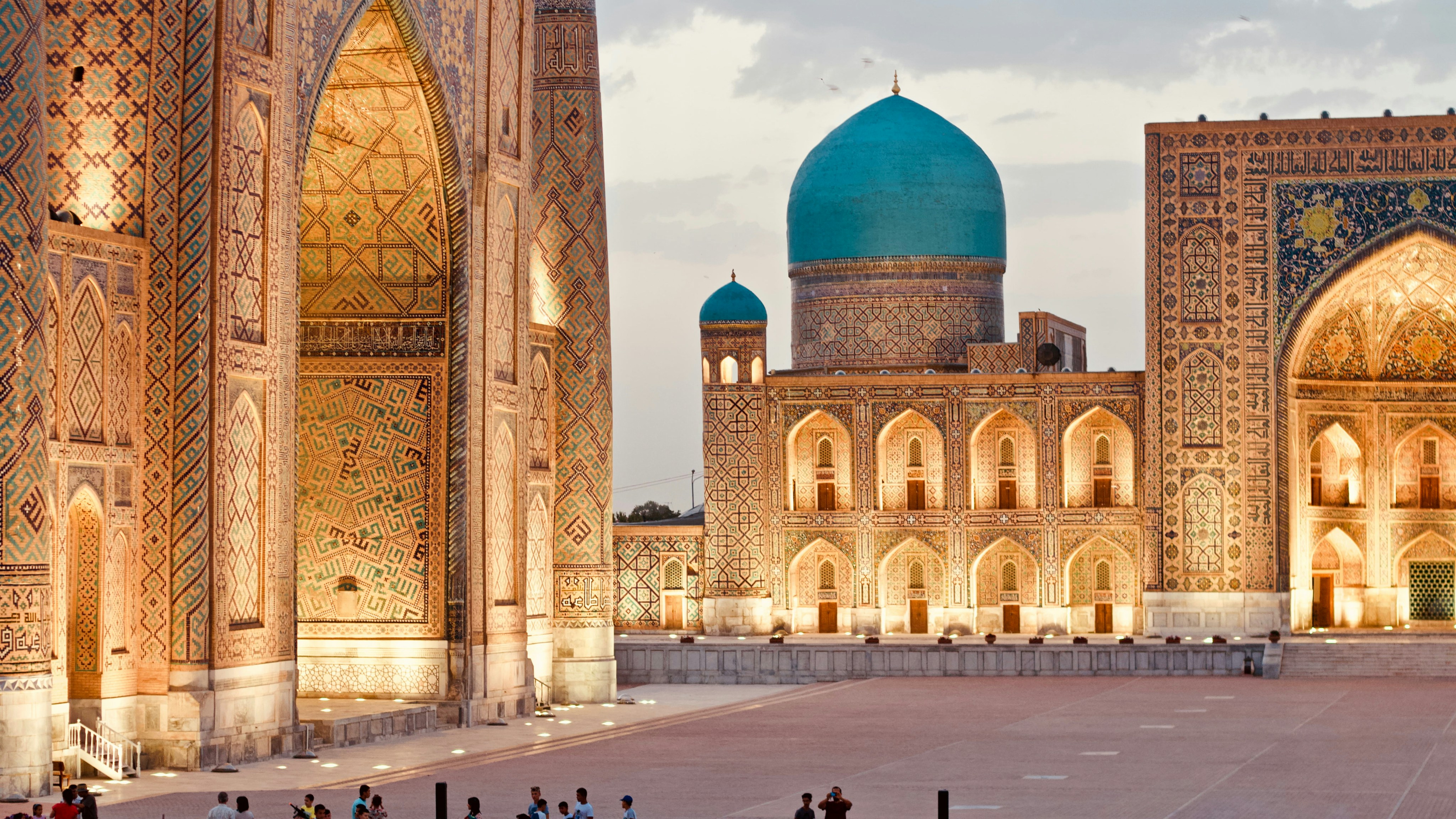 Samarkand’s Registan Square, with richly tiled madrasahs and blue domes in the evening light.