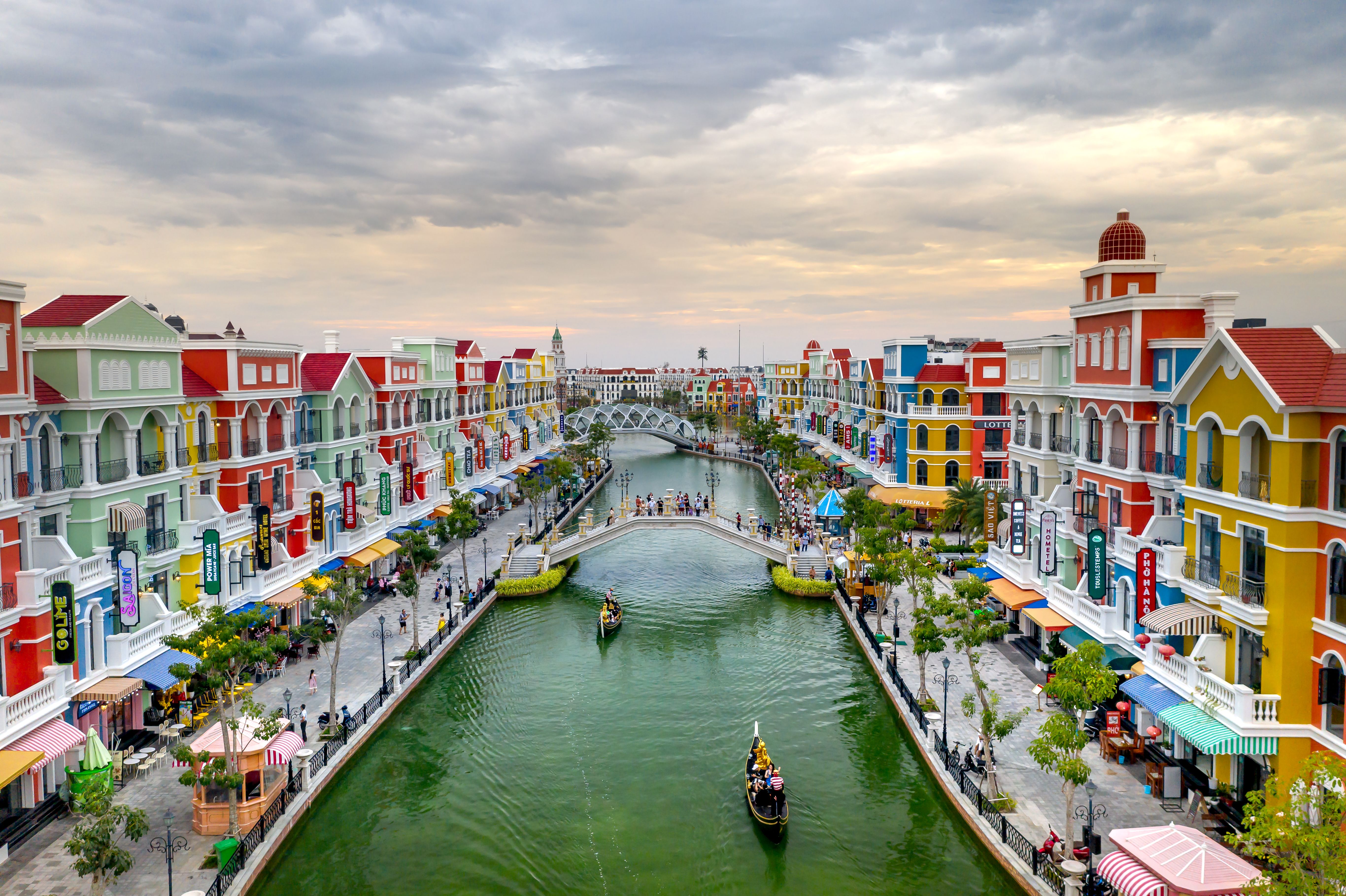 A colourful canal lined with European-style buildings and boats in Phu Quoc.