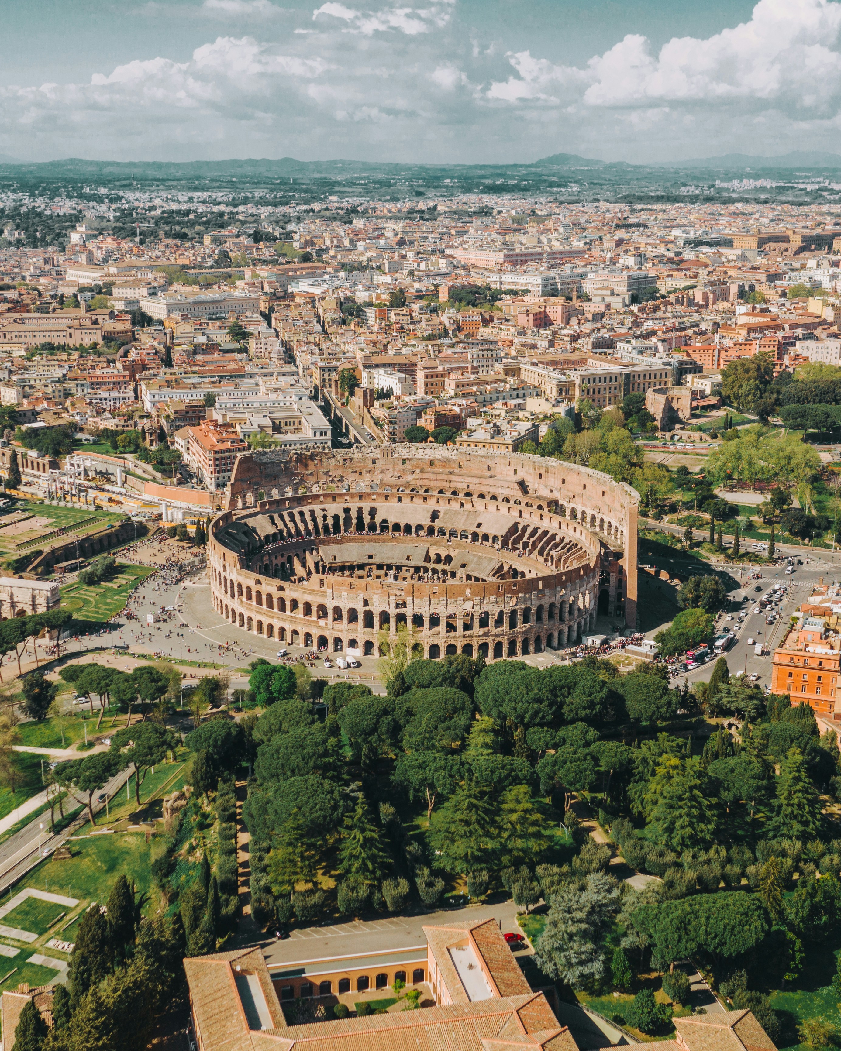 Aerial view of the Colosseum and surrounding archaeological site in Rome.