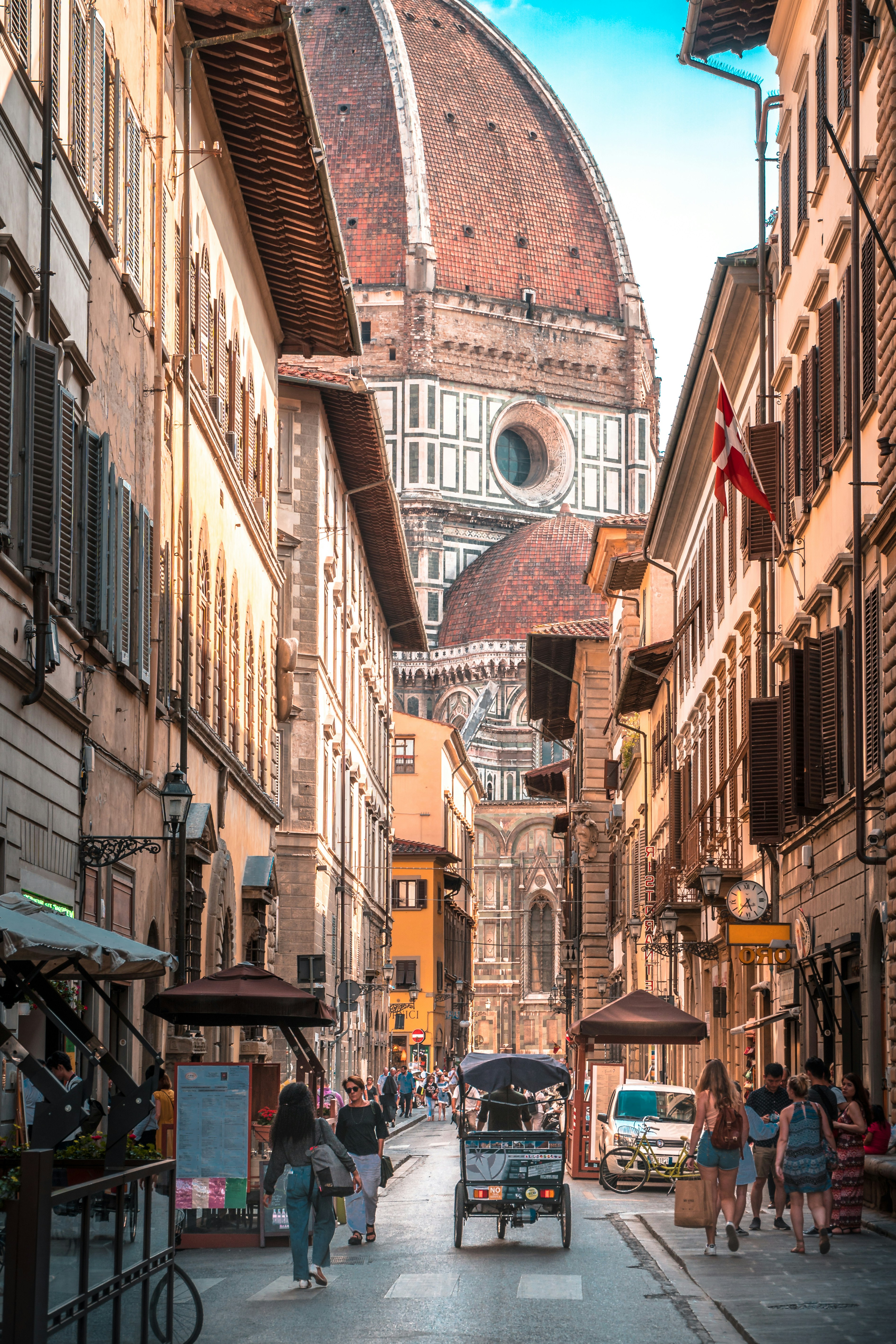 Florence Cathedral rises above a historic street.