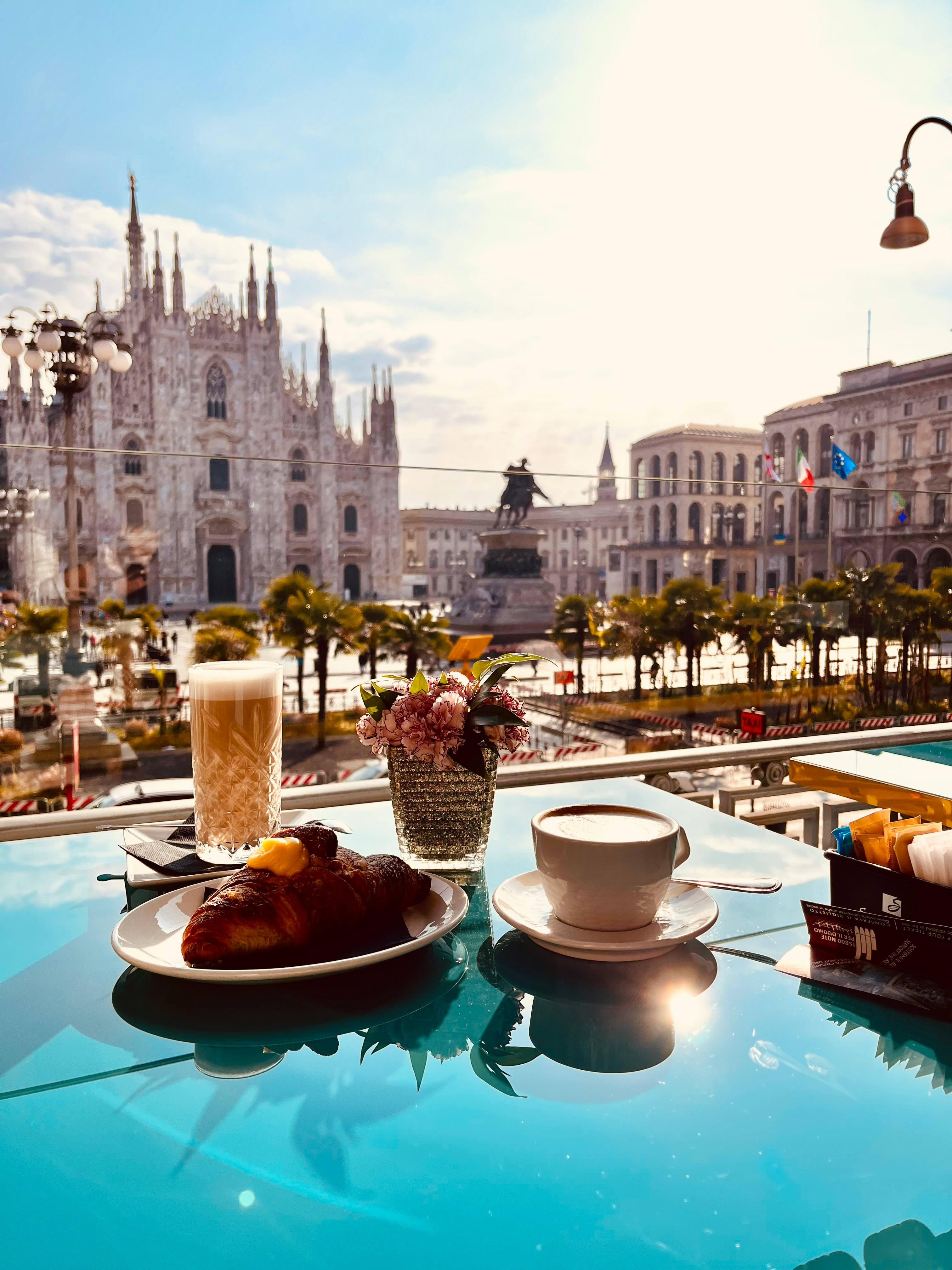 Coffee and pastry on a terrace overlooking Milan Cathedral.